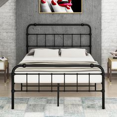 a black metal bed frame with white sheets and red shoes on the headboard, against a brick wall