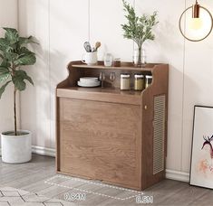 a small wooden cabinet with plants and spices on the top, next to a potted plant