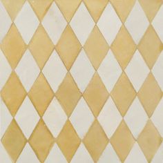 a white and yellow checkered tile with some brown dots on the bottom right corner