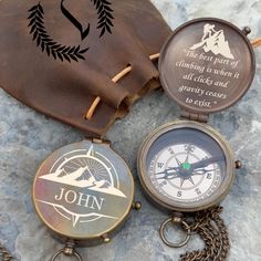 two compasss and a leather pouch with the words john on it sitting next to each other