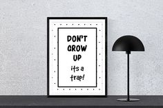 a black and white poster with the words don't grow up it's a trap