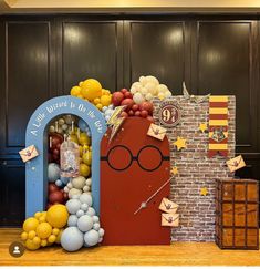 an entrance to harry potter themed birthday party with balloons and decorations on the front door