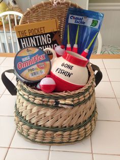 a basket filled with various items on top of a white tiled floor next to a table