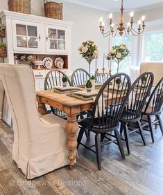 the dining room table is set with black chairs