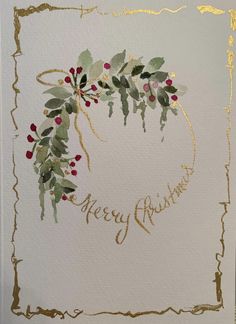 a christmas card with gold foil and holly berries on it, which reads merry christmas