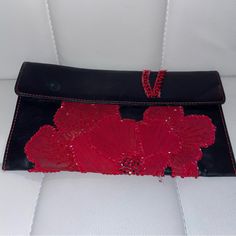 Giorgio Armani Vintage Leather Clutch W/ Red Flower Beads. Pre-Loved. Butter Soft Black Leather. Magnetic Closure. Small Pocket Inside; No Closure. Dime-Size Water Stain On Outside Flap; Blue/Green In Color. Beading & Stitching Are Not Intact. Small Stain On Inside Of Flap/ Red In Color. Stains On Outside Of Inside Pocket. Minimal Scratches. Authentic. Not Cleaned. Used. Buying Vintage Items Please Keep In Mind That Pieces Marked As Vintage Are Not In A New Condition, They Are Pre-Worn And Will Often Show Slight Signs Of Wear Or Normal Aging Red Embellished Evening Bag, Red Beaded Clutch For Party, Red Beaded Evening Bag, Red Embellished Clutch For Formal Occasions, Elegant Red Beaded Clutch, Elegant Red Embellished Evening Bag, Red Embroidered Clutch For Evening, Red Leather Evening Bag For Party, Luxury Handmade Red Clutch