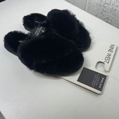 Stay Cozy And Stylish With These Nine West Black Fuzzy Slippers, Perfect For Lounging At Home. Designed For Women, These Small-Sized Slippers Offer Comfort And Warmth. Black Fuzzy Design Small Size Comfortable Fit Durable Material Perfect For Home Use Features: Casual Size: Womens S Condition: New With Tags Never Worn Black Winter Slippers With Round Toe, Black Slip-on Winter Slippers, Cozy Black Slip-on Slippers, Black Cozy Slippers With Round Toe, Black Flat Slippers For Winter, Black Flat Winter Slippers, Black Round Toe Slippers For Fall, Comfortable Black Slippers For Streetwear, Comfortable Black Slippers For Fall