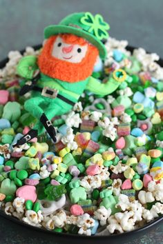 a st patrick's day treat is in a bowl full of candy and marshmallows