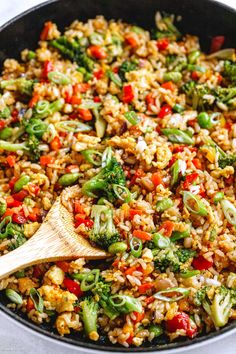 a skillet filled with rice and vegetables