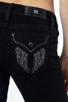 - Mid-rise, black bootcut jeans- Dark grey embroidery with hints of metallic silver and black stitching throughout downturn wing design- Mini grey rhinestone rivets throughout design with a faux flap pocket- Black rhinestone rivets- Black leather M logo brand patch- 5-pocket design- 70% Cotton 20% Polyester 8% Viscose 2% Elastane- Gentle machine wash inside-out with like colors in cold water, Tumble dry low Model is wearing size: 25 Model Measurements: Height: 5'10" Bust: 32" Waist: 25.5" Hips: 36" Style No. M5082B162-B01, M5082B162S-B01, & M5082B162V-B01 Black Low Rise Jeans, Jean Pocket Designs, Grey Embroidery, Clothing Brand Logo, Black Bootcut Jeans, Wing Design, Chic Jeans, M Logo, Straight Clothes