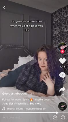 a woman laying on top of a bed in a bedroom