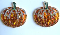 two orange and yellow pumpkin brooches with crystals