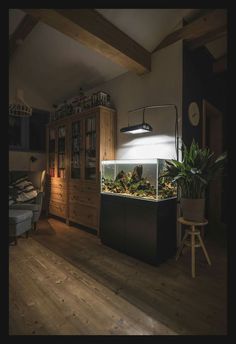 a fish tank sitting on top of a wooden floor