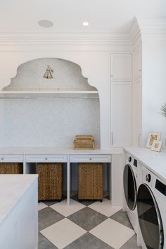 a washer and dryer in a white laundry room