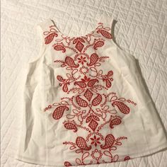 This Darling Tank Has Beautiful Red Embroidery On The Front And A Bow Detail In The Back. Nwt Red Sleeveless Tops With Floral Embroidery, Sleeveless Red Tops With Floral Embroidery, Red Sleeveless Top With Floral Embroidery, Red Embroidered Casual Top For Summer, Casual Red Embroidered Top For Summer, White Tops With Machine Embroidery For Spring, White Machine Embroidered Tops For Spring, Red Embroidered Top With Floral Embroidery For Spring, Red Floral Embroidered Top For Spring