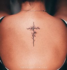 a woman with a cross tattoo on her back