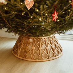 a christmas tree in a basket with ornaments on it