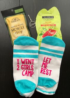 two pairs of socks with the words i went 2 girls rest on them next to some snacks