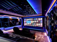 a home theater is lit up with blue lights and black leather seats, while the walls are