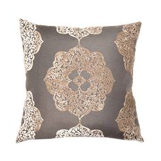 a gray and gold pillow with an intricate design on the front, sitting on a white background