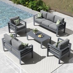 an outdoor patio furniture set near a pool