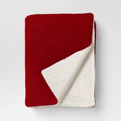 the red and white blanket is folded up