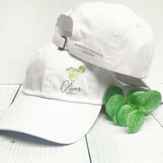 These custom margarita baseball hats are perfect for a final fiesta bachelorette, Mexico girls trip, birthday, or other boozy celebration. Personalize each hat with a name or location in modern script lettering.  Optional - add 1-2 lines of custom text to the back of each hat.  𝗣𝗘𝗥𝗦𝗢𝗡𝗔𝗟𝗜𝗭𝗔𝗧𝗜𝗢𝗡 * Add  a name or location (printed in script - up to 12 characters maximum) 𝗢𝗣𝗧𝗜𝗢𝗡𝗔𝗟: Add 1-2 lines of short custom text to each hat 3.00 per hat)  (printed in ALL CAPS - 25 characte Summer Birthday Snapback Hat, Summer Snapback Hats For Birthday, White Adjustable Hat For Bachelorette Party, Fun White Baseball Cap, Fun White Brimmed Baseball Cap, Adjustable Cap For Graduation Party, Casual White Trucker Hat For Party, Adjustable Brimmed Hat For Birthday, Personalized Summer Baseball Cap With Curved Brim