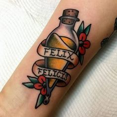 a tattoo on the arm of a person with a bottle and ribbon around it that says, felix felicis