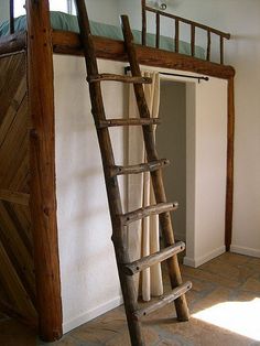 a wooden ladder leaning up against the wall