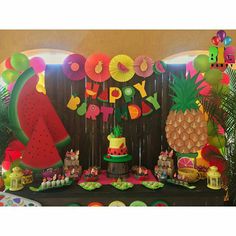 a birthday party with pineapples, watermelon and other decorations