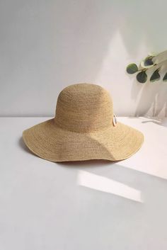 Chic Sun Protection for Stylish Escapes Enhance your summer look with our hand-woven straw sun hat, accented with natural seashells. This chic hat features a wide brim for ample sun protection and versatile styling with a flexible wire. Perfect for beach vacations and summer getaways. Style #: WWAJ518 Palm Leaf Sun Hat For Travel, Lightweight Natural Sun Hat For Sunbathing, Woven Toquilla Straw Sun Hat For Vacation, Summer Straw Hat In Natural Color For Beach, Natural Woven Sun Hat For Vacation, Beachy Woven Straw Hat For Travel, Vacation Woven Toquilla Straw Sun Hat, Wide Brim Paper Straw Hat For Sunbathing, Summer Straw Hat With Wide Brim