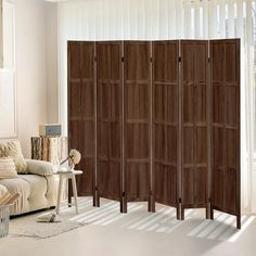 the room divider is made from wood and has four panels on each side,