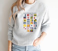 Vintage Nautical Flags Sweatshirt, Alphabet Flag Pullover, Gift for Sailors, Sailing Crewneck ►FEATURES ABOUT THE GARMENT  for any situation, a unisex heavy blend crewneck sweatshirt is pure comfort. These garments are made from polyester and cotton. This combination helps designs come out looking fresh and beautiful. The collar is ribbed knit, so it retains its shape even after washing. There are no itchy side seams on these sweaters.  .: 50% cotton, 50% polyester .: Medium-heavy fabric (8.0 oz Nautical Shirt Design, Nautical Shirt, Sports Wear Fashion, Gifts For Sailors, Nautical Flags, Vintage Nautical, Nautical Fashion, Sew-in Labels, Heavy Fabric