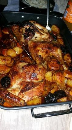 a roasting pan filled with chicken and potatoes