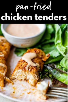 chicken tenders on a plate with salad and dressing