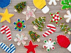 decorated cookies are arranged on a wooden surface