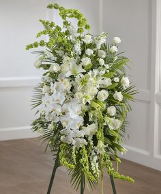 a bouquet of white flowers on a stand