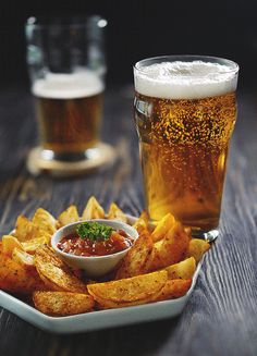 a plate of chips and beer on a table