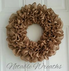 a burlock wreath hanging on a door with the words, notate wreaths