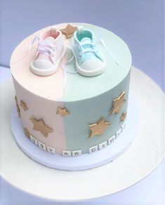 a cake decorated with baby's shoes and stars