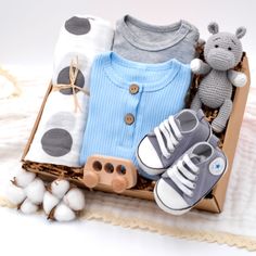 This Gift Set includes: Cotton Muslin Polka Dot Swaddle Blanket: A breathable, lightweight swaddle blanket featuring a chic polka dot design. It's large enough to snugly wrap the baby and soft enough for sensitive skin. Cotton Blue Pajama Romper: This adorable blue romper is made from soft cotton and features natural coconut shell buttons for easy dressing. Gray Cotton Pajama Romper: A versatile, cozy gray romper that's perfect for sleep or play, made from soft cotton for comfort. Knit Hippo Rattle Toy: A charming knit hippo rattle that's easy for tiny hands to hold and shake, with a gentle sound to entertain the baby. Sneaker Style Booties: Fashionable sneaker-style booties that combine cuteness with comfort. They're soft, flexible, and great for completing any outfit. Newborn Gift Boxes, Baby Boy Gift Set, Harry Potter Baby Shower, Gray Romper, Soft Bath Towels, Harry Potter Baby, Tiny Hands, Pajama Romper, Baby Boy Gift