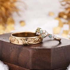 two wedding rings sitting on top of a wooden box