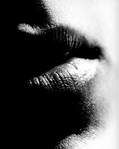 a black and white photo of someone's lips