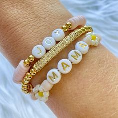 This listing is for the Daisy May Mama Bracelets. Set of 3 Heishi beaded bracelet with gold accent bracelets, This go-to everyday bracelet stack is simple but adds the perfect subtle touch of sparkle you can wear anywhere and anytime. These bracelets are stretch and best rolled on and off to extend their life. Wear each bracelet alone or all together. This stack makes a great gift for moms, grandparents, aunts, teachers, brides, the list is endless.  Bracelets in this Stack: Main- Mama with 1 wh Adjustable Beaded Bracelets With Spacer Beads For Mother's Day, Beaded Pearl Bracelet For Mother's Day, Adjustable Bracelet With Spacer Beads For Mother's Day, Heishi Beads Letter Bracelets For Jewelry Making, Beaded Stretch Bracelet For Mother's Day, Mother's Day Beaded Stretch Bracelet With Round Beads, Stretch Beaded Bracelet For Mother's Day, Mother's Day Letter Beads Beaded Bracelets, Mother's Day Beaded Bracelets With Letter Beads