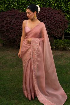 Pink saree, featuring long cascading hem, hand embroidered floral motifs on border. Comes with an unstitched blouse piece.
Components:2
Embroidered
Neckline:
Sleeve Length:
Fabric:Organza Satin Silk
Color:Pink
Hand embroidered border on saree
Note: The blouse worn by the model is for styling purpose only - Aza Fashions Saree Inspo For Wedding, Silk Saree Outfit Ideas, Elegant Saree For Wedding, Festive Saree Look, Saree In Wedding, Simple Elegant Saree, Fancy Sarees Wedding Reception, Pink Saree Wedding, Saree Look Traditional