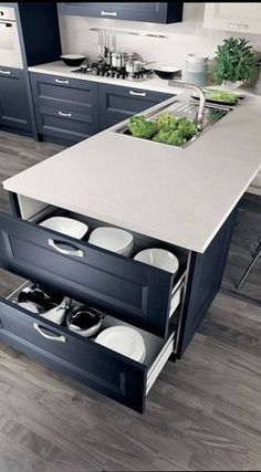 an open drawer in the middle of a kitchen