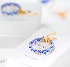 a white box with some blue and gold bracelets on it