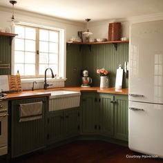 a white refrigerator freezer sitting inside of a kitchen