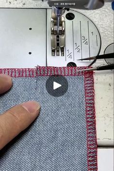 someone is working on the sewing machine with their thumbnails and hand stitching