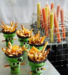 an article in the magazine about food made from plastic cups with faces and sticks sticking out of them